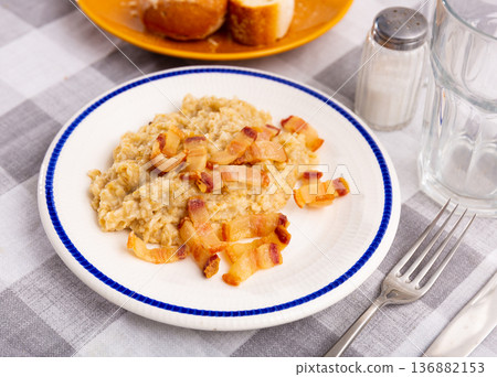 Oatmeal porridge served with fried lard 136882153