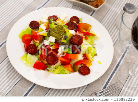 Feta and chorizo salad with avocado and pesto sauce Feta and chorizo salad with avocado and pesto sauce 136882229