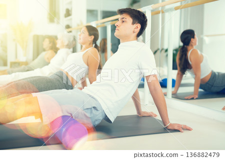 Young boy doing pilates with roller 136882479