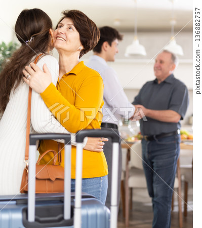 Parents joyfully welcome their adult children who have come to visit from far away Parents joyfully welcome their adult children who have come to visit from far away 136882757