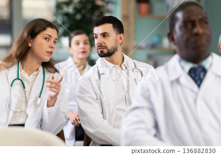 During lecture meeting, adult medical pupils listen and look to teacher During lecture meeting, adult medical pupils listen and look to teacher 136882830