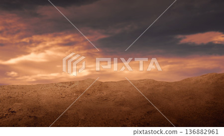 Dramatic low-angle view of a sandy desert mound under a fiery sunset sky with dark storm clouds and golden light. Ideal for cinematic backgrounds and conceptual themes 136882961