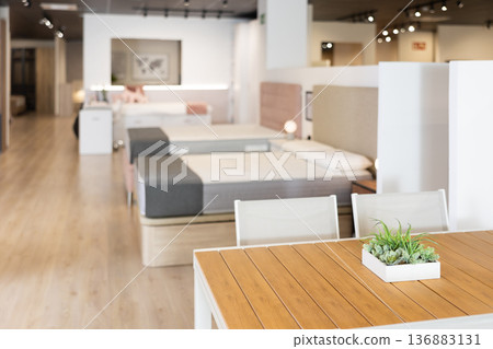 Interior of modern furniture salon shopping room with tables and sofas 136883131