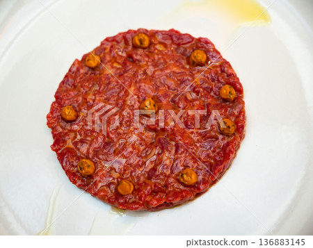 Beef tartare with drops of yolk sauce and drizzle of olive oil Beef tartare with drops of yolk sauce and drizzle of olive oil 136883145