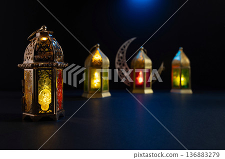 Ornamental Arabic lantern with burning candle glowing at night. Festive greeting card Ornamental Arabic lantern with burning candle glowing at night. Festive greeting card 136883279