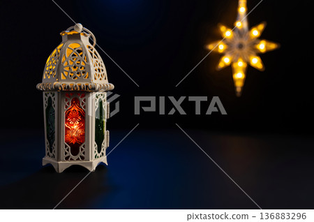 Ornamental Arabic lantern with burning candle glowing at night. Festive greeting card Ornamental Arabic lantern with burning candle glowing at night. Festive greeting card 136883296