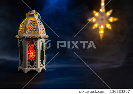 Ornamental Arabic lantern with burning candle glowing at night. Festive greeting card Ornamental Arabic lantern with burning candle glowing at night. Festive greeting card 136883297