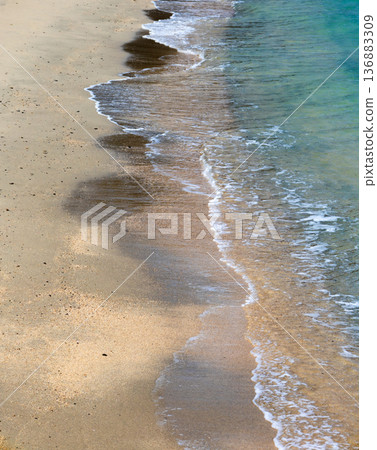 The shoreline of an empty beach on Ogijima Island in Kagawa Prefecture, located in the Seto Inland Sea 136883309