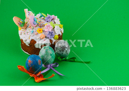 Colorful cake with decorations placed on a bright green background Colorful cake with decorations placed on a bright green background 136883623
