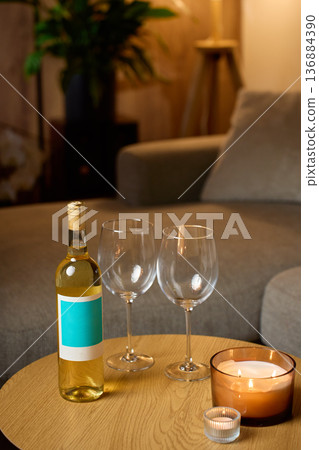 Bottle of white wine with two glasses and candles at home 136884390