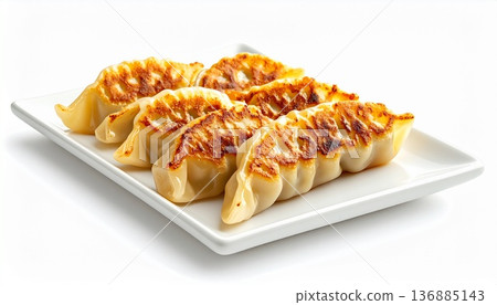 Juicy dumplings cooked to a golden brown. A simple and easy-to-use photo of Chinese dim sum and snacks on a white background. 136885143