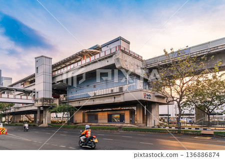 View of the Mo Chit BTS Skytrain station structure over Phahonyothin Road during the late afternoon in the Chatuchak district 136886874