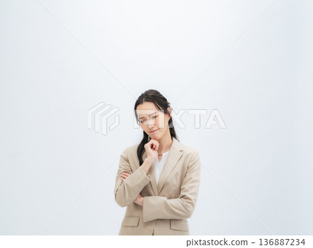 A female business person with a depressed expression A female business person with a depressed expression 136887234
