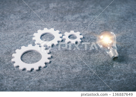 Data driven business marketing strategy promotes innovation, analytics process and market decision making concept shown with glowing light bulb and white gears on gray surface Data driven business marketing strategy promotes innovation, analytics process and market decision making concept shown with glowing light bulb and white gears on gray surface 136887649