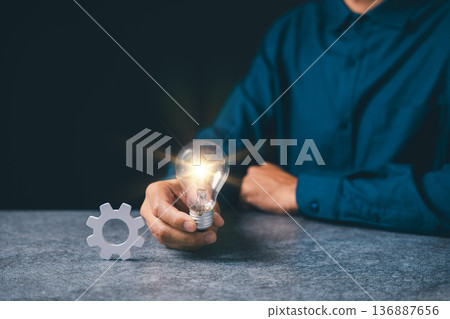 Manager holding light for iDeas, concept of project business gear management devops process automation deploy, providing efficient workflow for success and corporate innovation Manager holding light for iDeas, concept of project business gear management devops process automation deploy, providing efficient workflow for success and corporate innovation 136887656