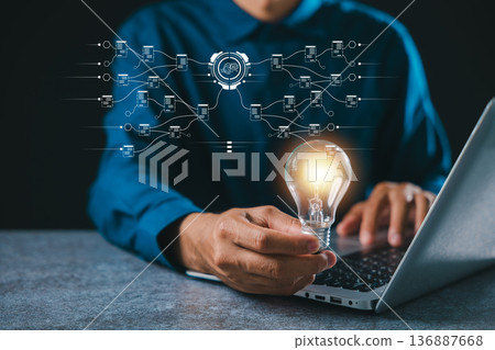 Idea for business innovation, professional uses ai technology generating creative solutions, holding bright lightbulb representing digital concept and future tech development 136887668