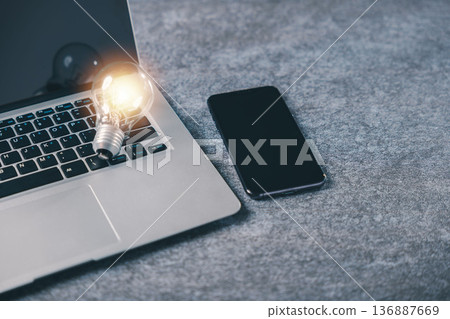 Strategy for marketing and business growth shows glowing light bulb on laptop keyboard representing innovative strategy and creative idea for concept solution energy development Strategy for marketing and business growth shows glowing light bulb on laptop keyboard representing innovative strategy and creative idea for concept solution energy development 136887669