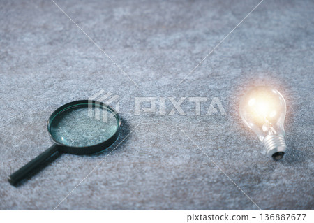 College student explores college career path options using magnifying glass, bright lightbulb represents innovation, creative business concept shows insight for college achievement College student explores college career path options using magnifying glass, bright lightbulb represents innovation, creative business concept shows insight for college achievement 136887677