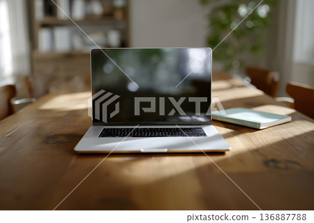 Laptop is sitting on a wooden table Laptop is sitting on a wooden table 136887788