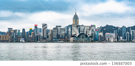 HONG KONG CHINA - DECEMBER 29 2025: Hong Kong Convention and Exhibition Centre waterfront building Victoria Harbour skyline skyscrapers architecture business district 136887803