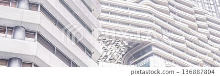 Abstract architectural pattern curved lines modern building facade detail white grey metallic texture futuristic urban design exterior geometric shape structure wall 136887804