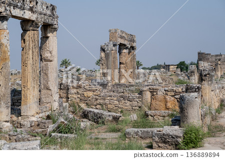 Exploring the Ancient Ruins of Pamukkale Showcasing Stunning Columns and Stone Structures Under a Clear Blue Sky Exploring the Ancient Ruins of Pamukkale Showcasing Stunning Columns and Stone Structures Under a Clear Blue Sky 136889894