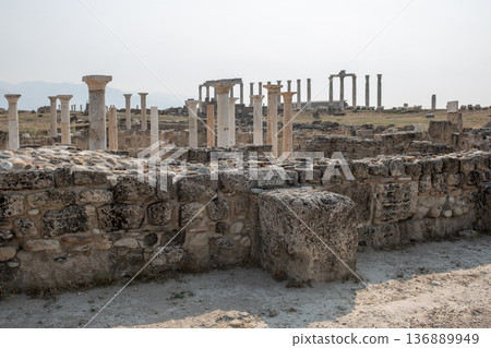 Explore the Historical Ruins of the Ancient Town of Laodikeia Featuring Stone Structures and Towering Columns in a Serene Landscape 136889949