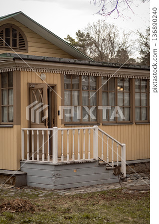 Charming Wooden House With a Welcoming Porch in a Serene Neighborhood During Late Afternoon Charming Wooden House With a Welcoming Porch in a Serene Neighborhood During Late Afternoon 136890240