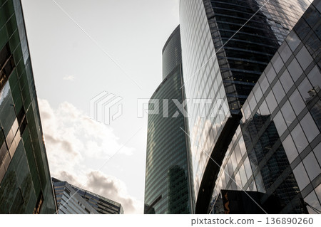 Modern Skyscrapers Rise Above the Streets of Moscow Under a Cloudy Sky During the Late Afternoon Modern Skyscrapers Rise Above the Streets of Moscow Under a Cloudy Sky During the Late Afternoon 136890260
