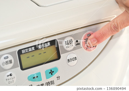 Image of operating the switch on a kerosene fan heater Image of operating the switch on a kerosene fan heater 136890494