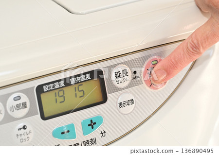 Image of operating the switch on a kerosene fan heater Image of operating the switch on a kerosene fan heater 136890495