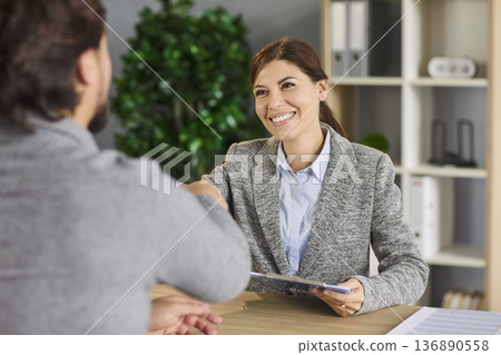Handshake on job interview of recruiter and vacancy candidate in business office 136890558