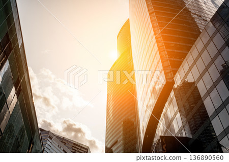 Modern Skyscrapers Reaching Towards the Sky in Moscow at Sunset With Warm Golden Light Illuminating the Glass Facades Modern Skyscrapers Reaching Towards the Sky in Moscow at Sunset With Warm Golden Light Illuminating the Glass Facades 136890560