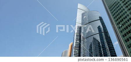 Modern Skyscrapers Reflect Sunlight Against a Clear Blue Sky in Moscows Bustling Cityscape Modern Skyscrapers Reflect Sunlight Against a Clear Blue Sky in Moscows Bustling Cityscape 136890561