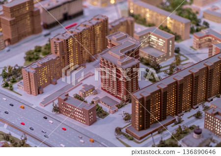 Detailed Architectural Model Showcasing a Modern Urban Development Project at Night With Illuminated Buildings in a City Setting 136890646