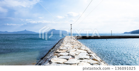 A view of the breakwater at Ogi Fishing Port on Ogi Island in Kagawa Prefecture, which is located in the Seto Inland Sea A view of the breakwater at Ogi Fishing Port on Ogi Island in Kagawa Prefecture, which is located in the Seto Inland Sea 136891025