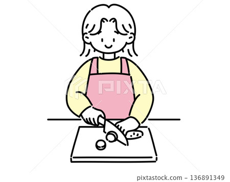 A woman who cuts vegetables with a kitchen knife 136891349