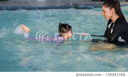 preschool child girl playing and swimming with her mother in pool preschool child girl playing and swimming with her mother in pool 136891388