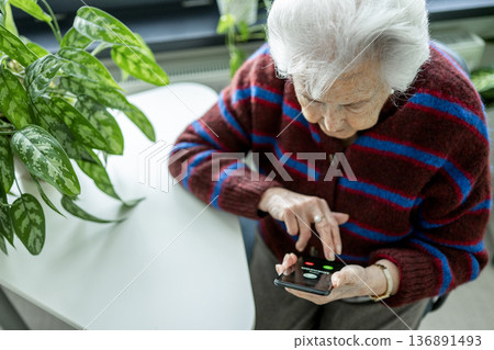 Senior facing phone scams and digital safety. Senior facing phone scams and digital safety. 136891493