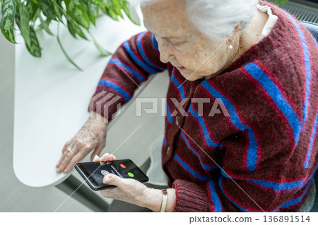 Senior facing phone scams and digital safety. Senior facing phone scams and digital safety. 136891514