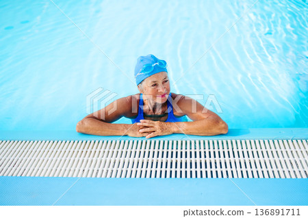 Elderly woman enjoying sport swimming for vitality and longevity. 136891711