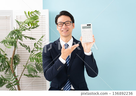 A man with a calculator 136892236