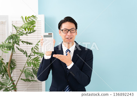 A man with a calculator 136892243