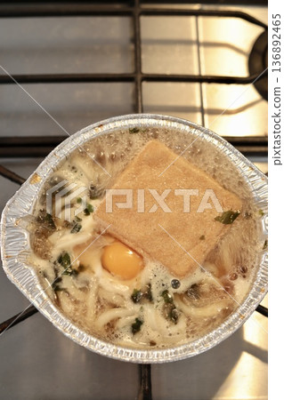Nabeyaki udon noodles being boiled in an aluminum pot Nabeyaki udon noodles being boiled in an aluminum pot 136892465