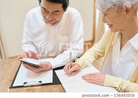 Senior Asian couple calculating household finances Senior Asian couple calculating household finances 136893850