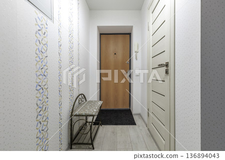 Cozy Apartment Entryway with Wooden Door and Patterned Wallpaper Cozy Apartment Entryway with Wooden Door and Patterned Wallpaper 136894043