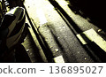 Motorcycle's Tail and Road Markings Under Dramatic Sunlight and 136895027