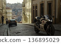 Sportbike parked on cobblestone street with distant cityscape vi 136895029