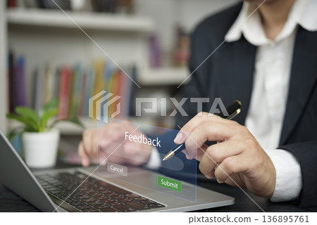 Businessman hand use laptop submit online feedback. Virtual interface, customer service survey. Business technology, user experience, satisfaction review. Submit button, corporate office. 136895761