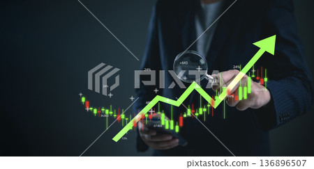 Trader using smartphone for stock exchange trading analysis. Digital finance technology for business investment growth, checking uptrend profit data on virtual candlestick chart for success. Trader using smartphone for stock exchange trading analysis. Digital finance technology for business investment growth, checking uptrend profit data on virtual candlestick chart for success. 136896507